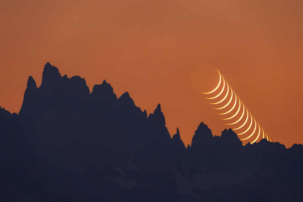 New Moon over mountain peaks